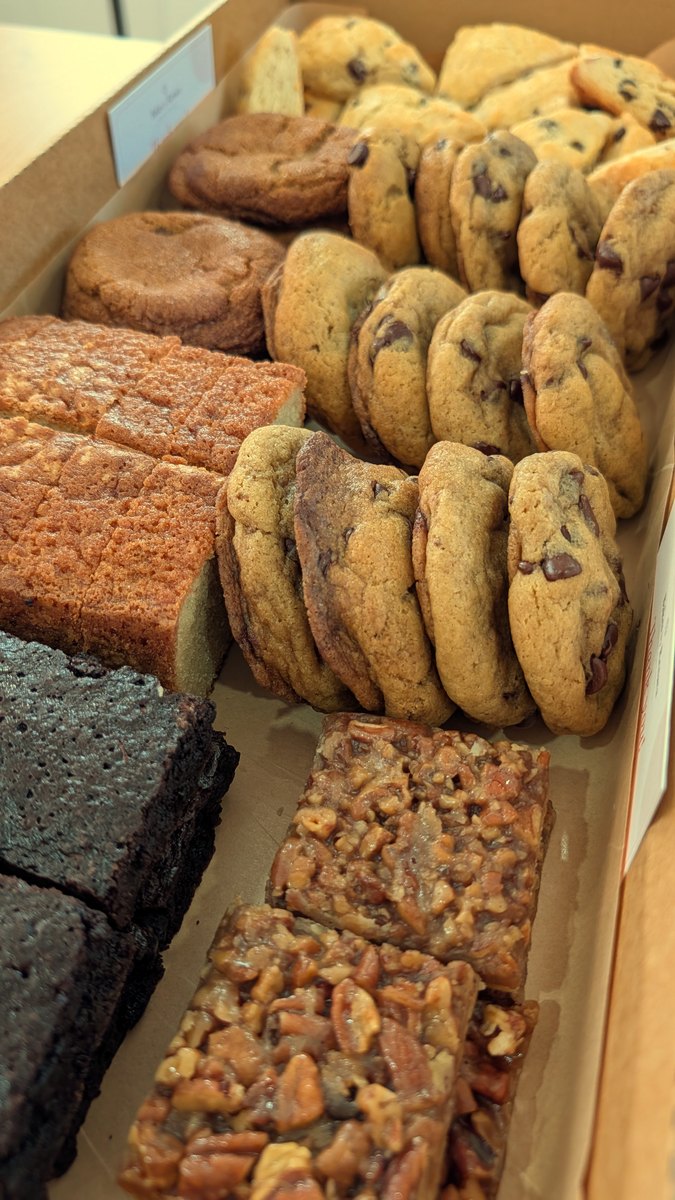 A large assorted bakery box of cookies, scones, blondies, brownies and pecan bars
