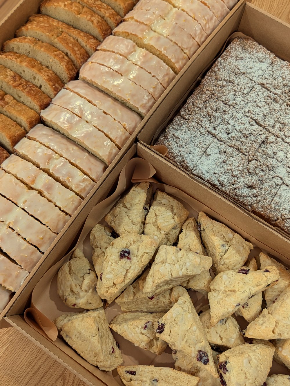 Boxes of lemon pound cake, crumb cake, and scones